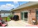 Wood deck features a grill, table set, and sliding glass doors to the brick home at 35 Decourcy Ln, Franklin, IN 46131