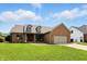 Charming brick home with well-manicured lawn and attached two car garage at 35 Decourcy Ln, Franklin, IN 46131