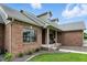 Close up of brick home showcasing the front porch, front door, and landscaping at 35 Decourcy Ln, Franklin, IN 46131