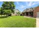 A lush front yard with a well-manicured lawn and mature trees, enhancing curb appeal at 35 Decourcy Ln, Franklin, IN 46131
