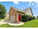 Two car detached garage featuring painted door, brick siding, and side entry door at 35 Decourcy Ln, Franklin, IN 46131