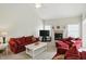 Bright and inviting living room with a fireplace, ceiling fan and plush seating at 35 Decourcy Ln, Franklin, IN 46131