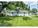 Lush backyard showcasing green grass and partial shade from a mature tree at 3617 Woodcliff Dr, Indianapolis, IN 46203