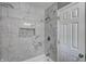 Bathroom with stylish marble tiling and an inset shower shelf at 3617 Woodcliff Dr, Indianapolis, IN 46203