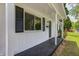 A cozy covered front porch with black trim offers an inviting entryway at 3617 Woodcliff Dr, Indianapolis, IN 46203