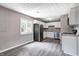 Eat-in kitchen with white cabinets, stainless steel appliances, and modern fixtures at 3617 Woodcliff Dr, Indianapolis, IN 46203