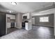 Eat-in kitchen with white cabinets, stainless steel appliances, and modern fixtures at 3617 Woodcliff Dr, Indianapolis, IN 46203