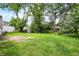 Picturesque backyard with lush green grass, shade trees, and a storage shed at 3663 Kline N Dr, Indianapolis, IN 46226