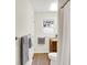 Bright bathroom with wood-look floor, wood vanity, and shower with white curtain at 3663 Kline N Dr, Indianapolis, IN 46226