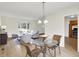 Open-concept space includes a dining area with a glass table and wicker chairs at 3663 Kline N Dr, Indianapolis, IN 46226