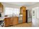 Kitchen featuring stainless steel appliances, wood cabinets, and a garden view at 3663 Kline N Dr, Indianapolis, IN 46226