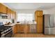 Kitchen featuring wood cabinetry, stainless steel appliances, and a window over sink at 3663 Kline N Dr, Indianapolis, IN 46226