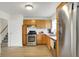 Well-lit kitchen features stainless steel appliances, wood cabinets, and modern finishes at 3663 Kline N Dr, Indianapolis, IN 46226