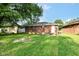 This home has a grassy backyard and brick exterior with a concrete patio at 3938 N Grand Ave, Indianapolis, IN 46226