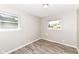 Bedroom featuring wood-look flooring, neutral walls, and double hung windows at 3938 N Grand Ave, Indianapolis, IN 46226