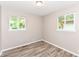 An empty bedroom offers wood floors, neutral paint, and two large windows at 3938 N Grand Ave, Indianapolis, IN 46226