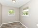 Bedroom featuring wood-look flooring, neutral walls, and double hung windows at 3938 N Grand Ave, Indianapolis, IN 46226