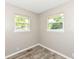 Cozy bedroom with wood-look floors, neutral paint, and two windows for ample natural light at 3938 N Grand Ave, Indianapolis, IN 46226