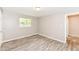 Bedroom featuring wood-look flooring, neutral walls, and double hung window at 3938 N Grand Ave, Indianapolis, IN 46226