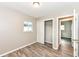 This bedroom features light gray walls and wood floors plus a window and closet at 3938 N Grand Ave, Indianapolis, IN 46226
