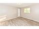 Bedroom featuring wood-look flooring, neutral walls, and double hung window at 3938 N Grand Ave, Indianapolis, IN 46226