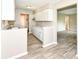 Updated kitchen featuring white cabinets, granite counters, and wood-look flooring at 3938 N Grand Ave, Indianapolis, IN 46226