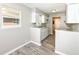 Compact kitchen featuring white cabinets, granite countertops, and wood-look flooring at 3938 N Grand Ave, Indianapolis, IN 46226