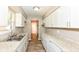 Galley kitchen featuring granite countertops, white cabinetry, stainless sink and modern lighting at 3938 N Grand Ave, Indianapolis, IN 46226