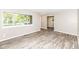 This updated living room offers neutral paint, wood floors, and large windows at 3938 N Grand Ave, Indianapolis, IN 46226
