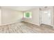 Bright living room featuring wood-look floors, neutral paint, and a window offering natural light at 3938 N Grand Ave, Indianapolis, IN 46226