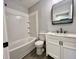 Beautifully updated bathroom with new fixtures, white vanity, and a shower-tub combo at 405 N Bradley Ave, Indianapolis, IN 46201