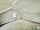Bedroom with vaulted ceiling, carpeting, and natural light from the window at 405 N Bradley Ave, Indianapolis, IN 46201
