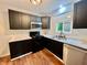 Updated kitchen featuring stainless steel appliances, black cabinetry and light countertops at 405 N Bradley Ave, Indianapolis, IN 46201