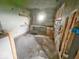 Interior shot of a room during demolition featuring exposed framework and demolition debris at 434 N Bradley Ave, Indianapolis, IN 46201
