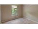 This bedroom features neutral walls, carpet floors, and a window that offers natural light and pleasant outdoor views at 4533 Golden Meadow Dr, Indianapolis, IN 46254