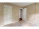 A carpeted bedroom with neutral walls and a door leading to another room or closet at 4533 Golden Meadow Dr, Indianapolis, IN 46254