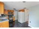 Well-lit kitchen featuring wood cabinets, modern black appliances, and tiled floors at 4533 Golden Meadow Dr, Indianapolis, IN 46254