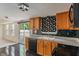 Traditional kitchen with wood cabinets, black appliances, and unique polka dot backsplash at 4533 Golden Meadow Dr, Indianapolis, IN 46254