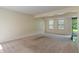 A spacious living room with carpet, light neutral colored walls, and natural light from sliding glass doors at 4533 Golden Meadow Dr, Indianapolis, IN 46254
