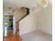 Open-concept layout with a staircase, view to kitchen, and a chandelier creating a welcoming atmosphere at 4533 Golden Meadow Dr, Indianapolis, IN 46254