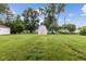 Spacious backyard featuring a white storage shed and a lush lawn at 4749 W Smith Valley Rd, Greenwood, IN 46142