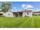 Spacious backyard featuring a covered patio, large lawn, and mature trees at 4749 W Smith Valley Rd, Greenwood, IN 46142