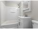 Updated bathroom with white vanity, medicine cabinet, and shower over tub at 4749 W Smith Valley Rd, Greenwood, IN 46142