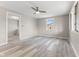 Well-lit bedroom featuring a modern ceiling fan and sleek, light-colored vinyl flooring at 4749 W Smith Valley Rd, Greenwood, IN 46142