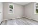 Bright bedroom with gray walls, new floors, and natural light from the two bright windows at 4749 W Smith Valley Rd, Greenwood, IN 46142