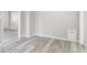 Bright living room with light gray walls and durable gray wood-look flooring throughout at 4749 W Smith Valley Rd, Greenwood, IN 46142