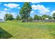 Spacious backyard featuring well-maintained grass and bordered by a wooden fence for added seclusion at 5120 Woodhurst Ln, Indianapolis, IN 46239