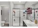 This bathroom offers a toilet, a glass-enclosed shower, and a sink with a cabinet at 5120 Woodhurst Ln, Indianapolis, IN 46239