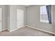 Cozy bedroom with neutral walls and a bright window, complemented by a white door at 5120 Woodhurst Ln, Indianapolis, IN 46239