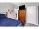 Comfortable bedroom featuring a wooden dresser with a TV on top and light-colored walls at 5120 Woodhurst Ln, Indianapolis, IN 46239